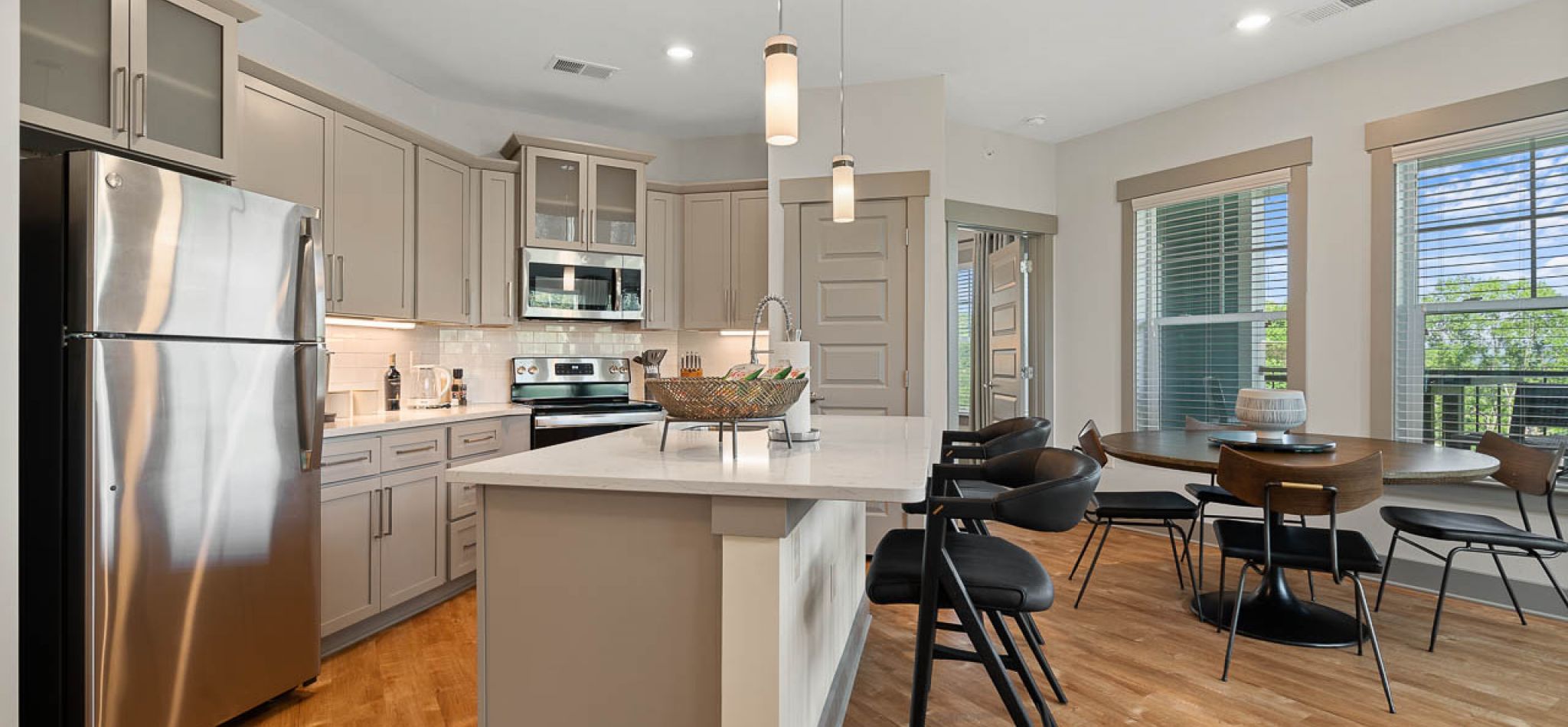 Hawthorne at Mills Gap beautiful apartment kitchen with kitchen island, quartz countertops, stainless steel appliances, 9ft ceilings