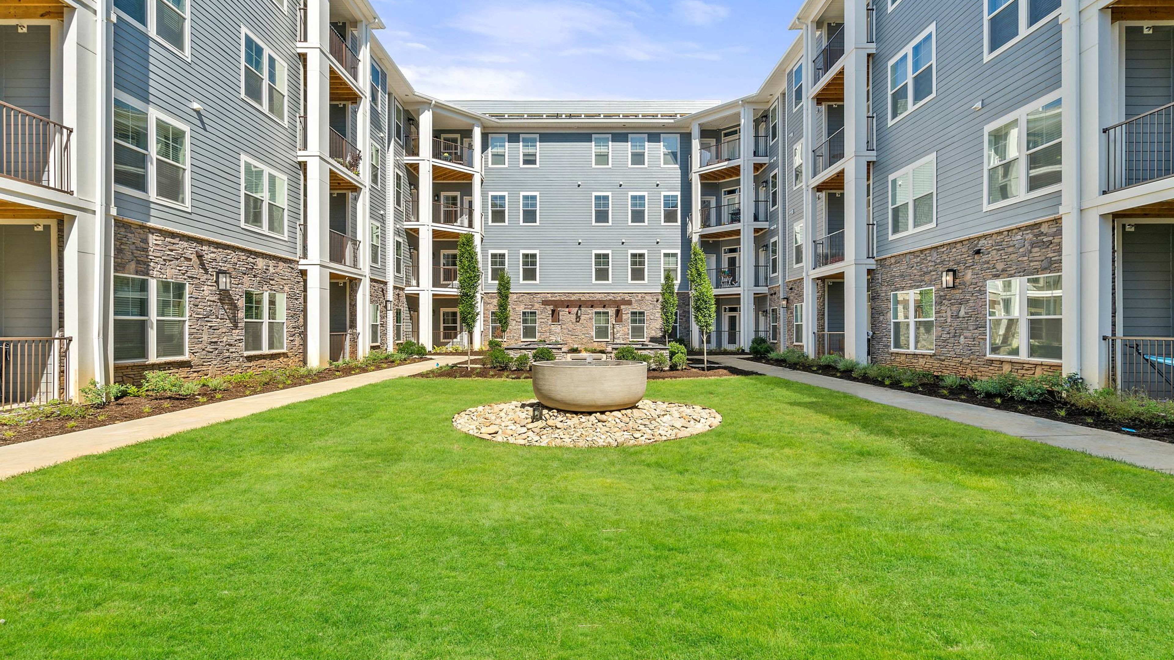 Hawthorne at Mills Gap apartments community exterior with large green lawn